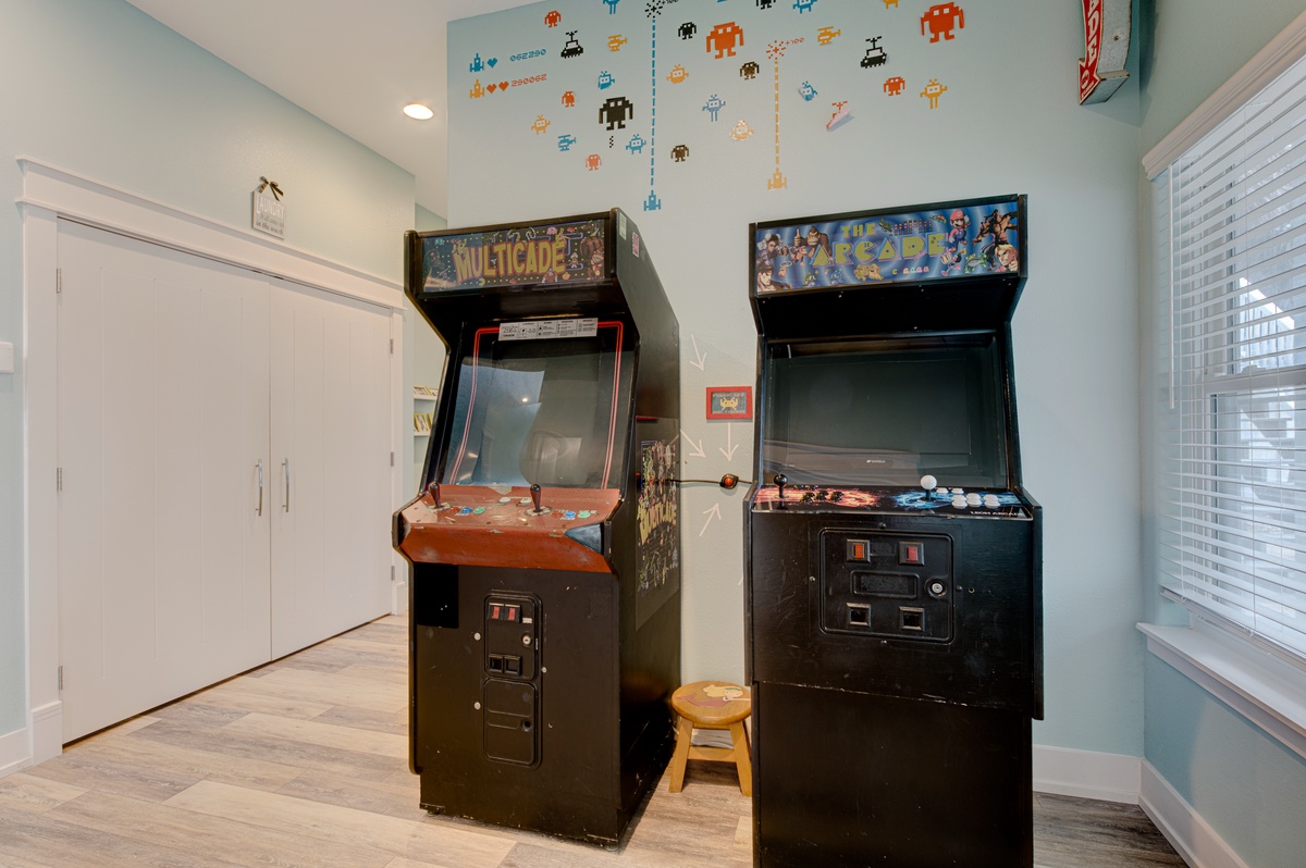 Your personal arcade awaits with classic games and whimsical wall art creating the perfect nostalgic gaming retreat.