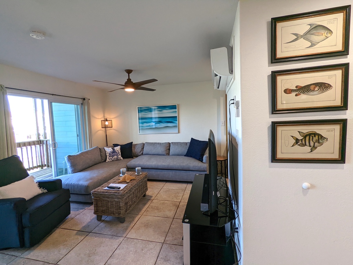 Sink into your spacious sectional and enjoy coastal vibes with charming fish artwork, ocean views, and modern comfort.