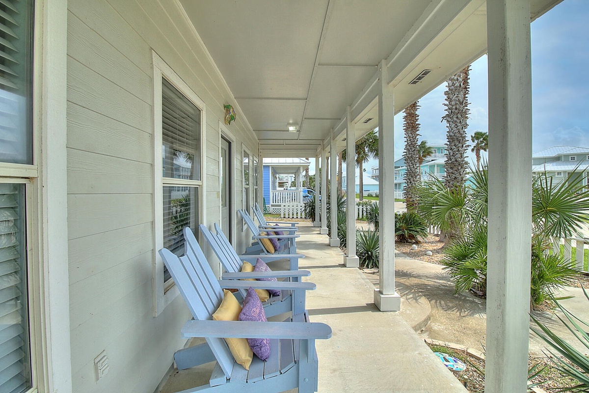Unwind on your covered porch with comfortable Adirondack chairs, where soft pillows and tropical breezes create the perfect spot to start each morning.