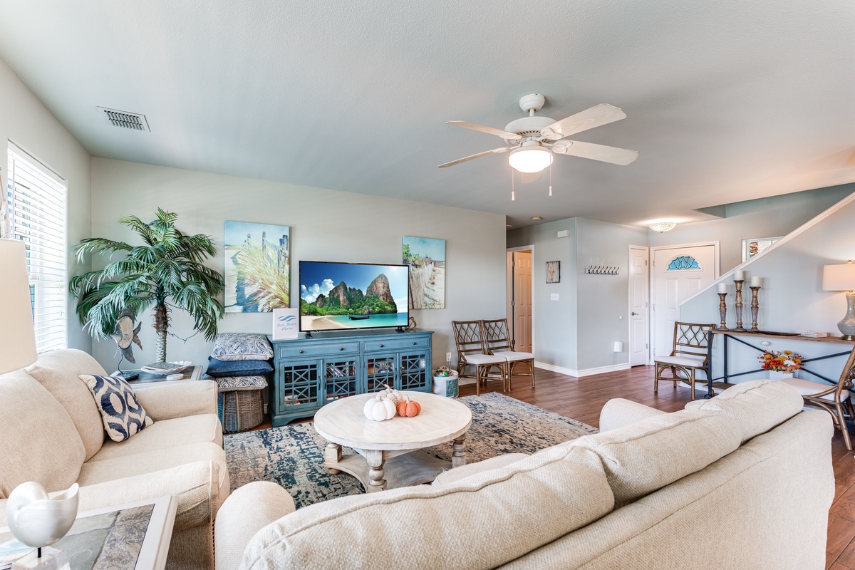Unwind in your bright, coastal-themed living space featuring plush seating and tropical touches that create the perfect vacation retreat.