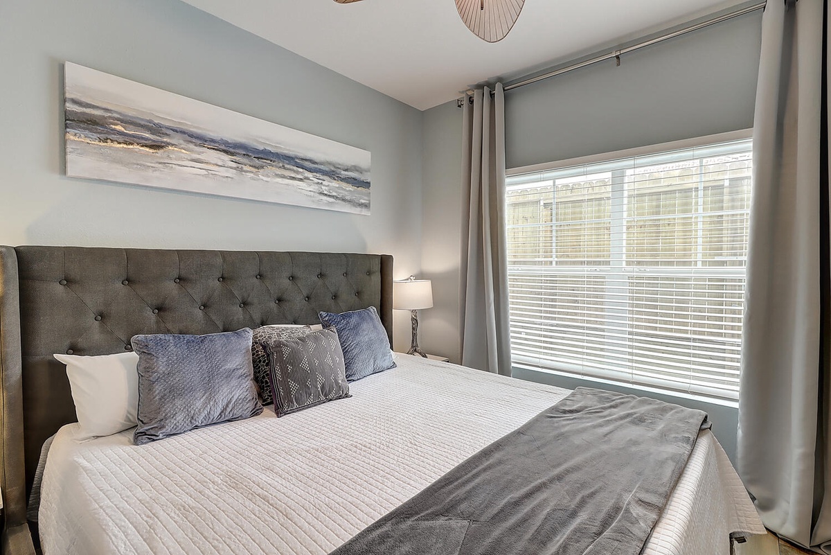 Drift into dreamland in this serene bedroom where soft blues and grays create your perfect retreat.