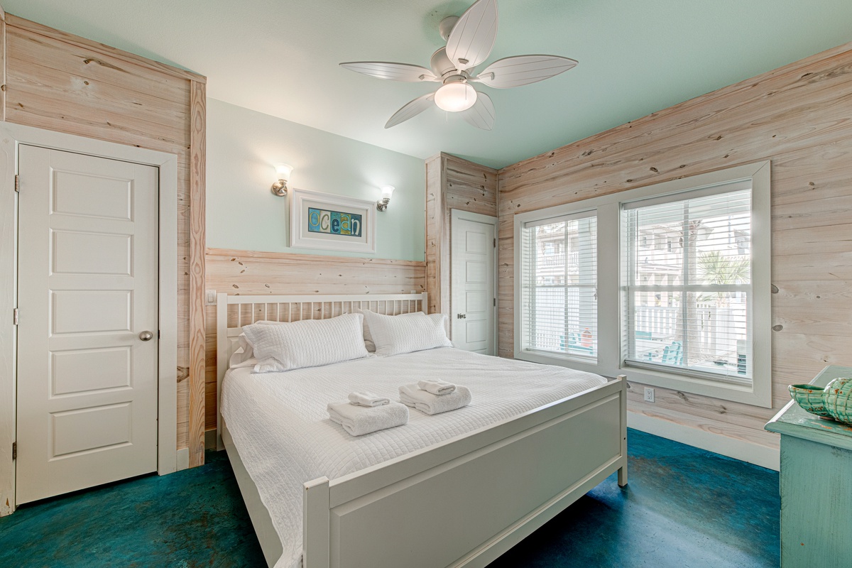 Drift off in this charming bedroom where rustic wood walls meet ocean-inspired decor. Your comfortable bed awaits with fresh linens.
