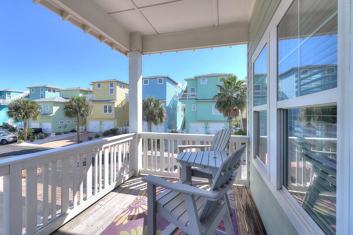 Relax on your private balcony with colorful coastal neighborhood views and comfortable seating for morning coffee or sunset drinks.