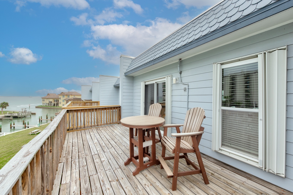 Step onto your private waterfront deck with stunning views of the bay and neighboring waterfront homes.