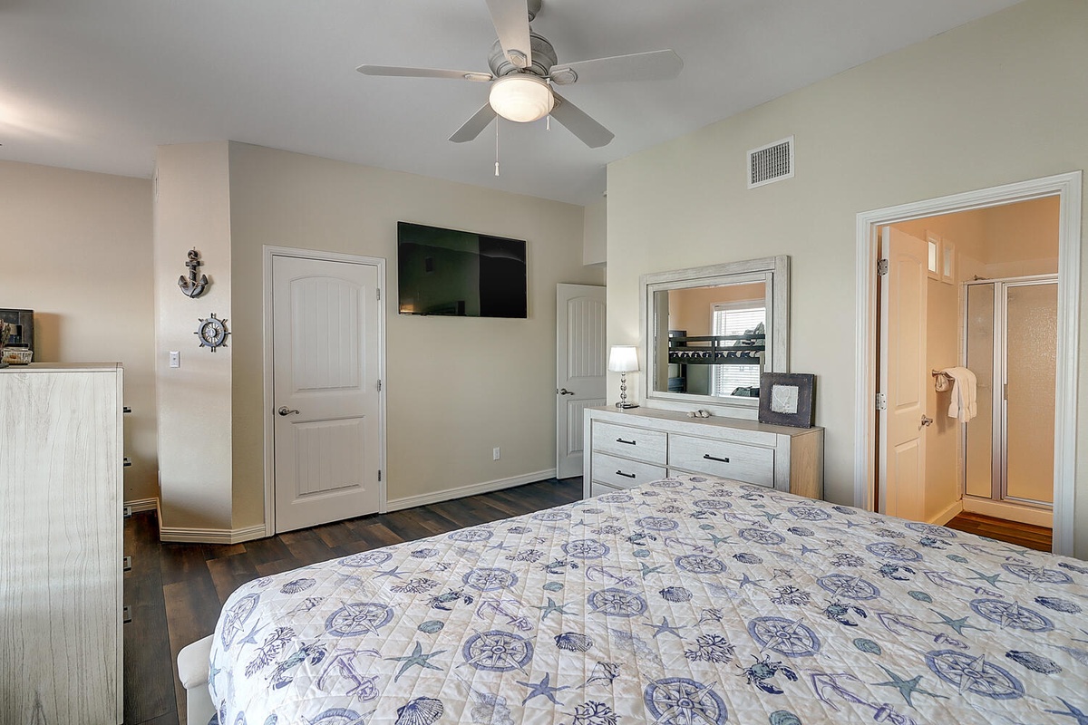 Drift off to sleep in your spacious bedroom, where nautical charm meets comfort with a cozy ceiling fan breeze overhead.