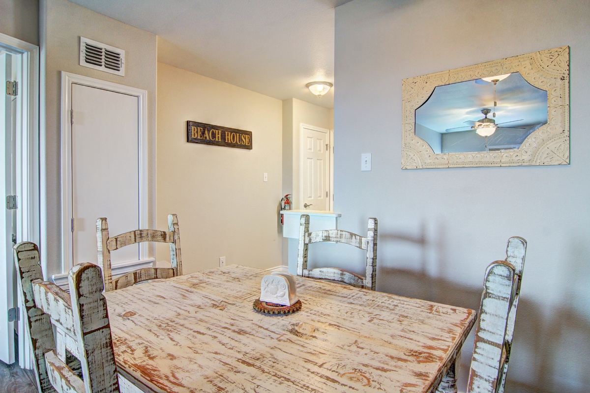 Your charming dining area features weathered coastal furniture and beach-themed décor, perfect for sharing meals with loved ones.