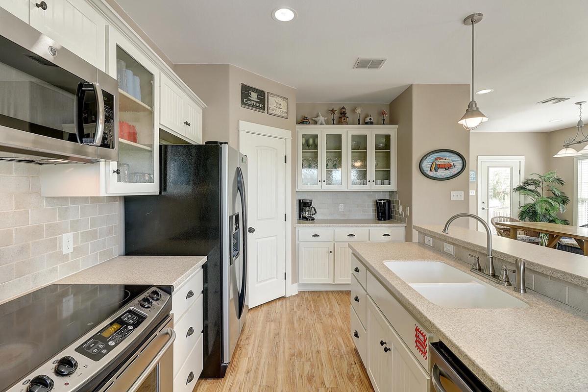 Your spacious kitchen features granite countertops, stainless appliances, and plenty of cabinet space for preparing memorable meals together.