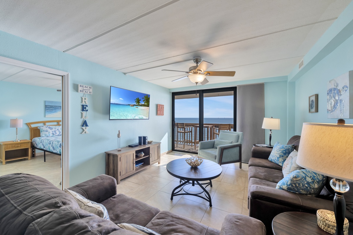 Relax in your ocean-view living room with coastal-themed decor and comfortable seating, perfect for unwinding after beach days.