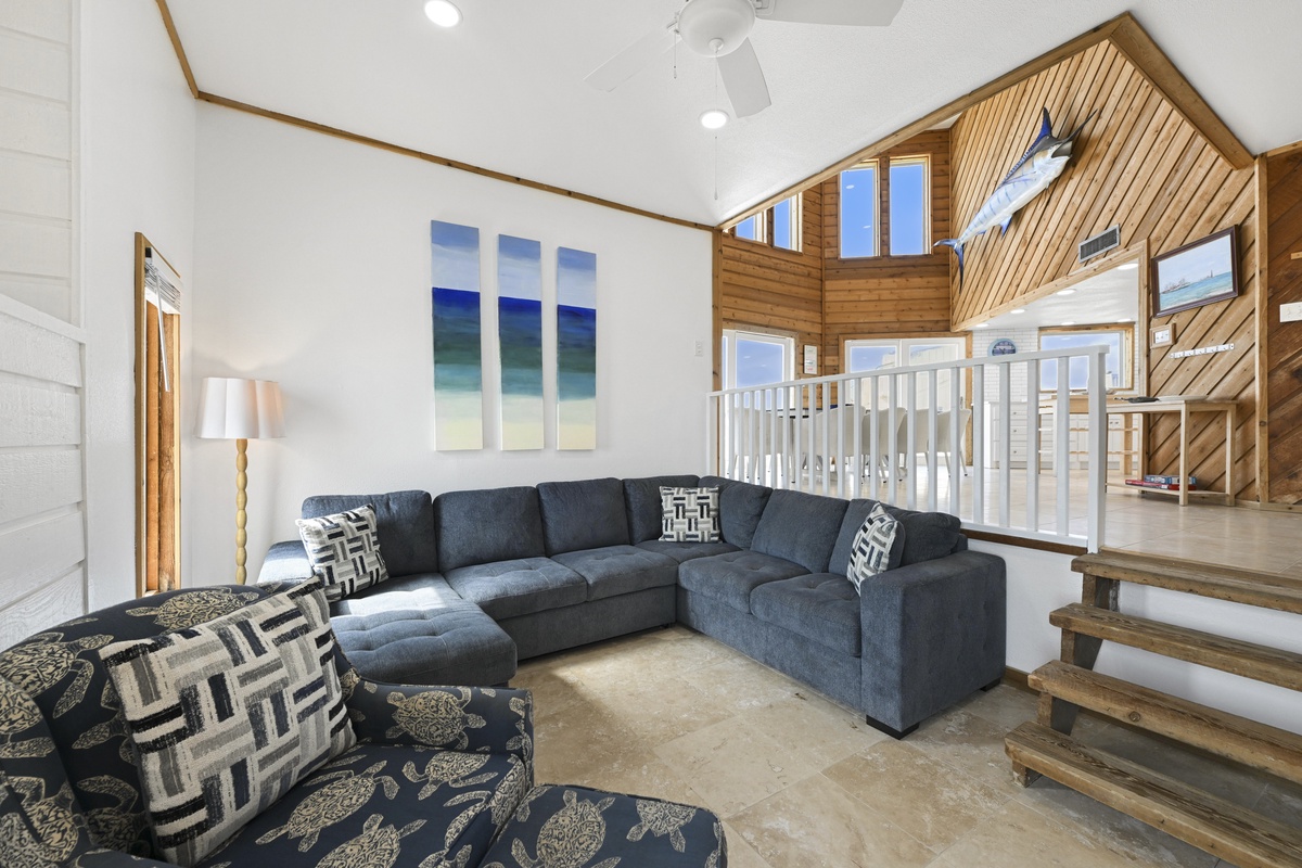Cozy lounge space with large windows, ideal for unwinding after a beach day.