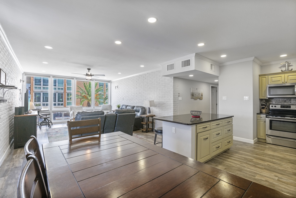 Unwind in your spacious open-plan retreat where modern comfort meets urban charm, featuring a stylish kitchen island perfect for morning coffee.