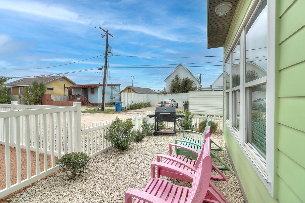 Charming residential neighborhood with colorful beach houses, power lines, and nearby homes creating an authentic coastal community atmosphere.