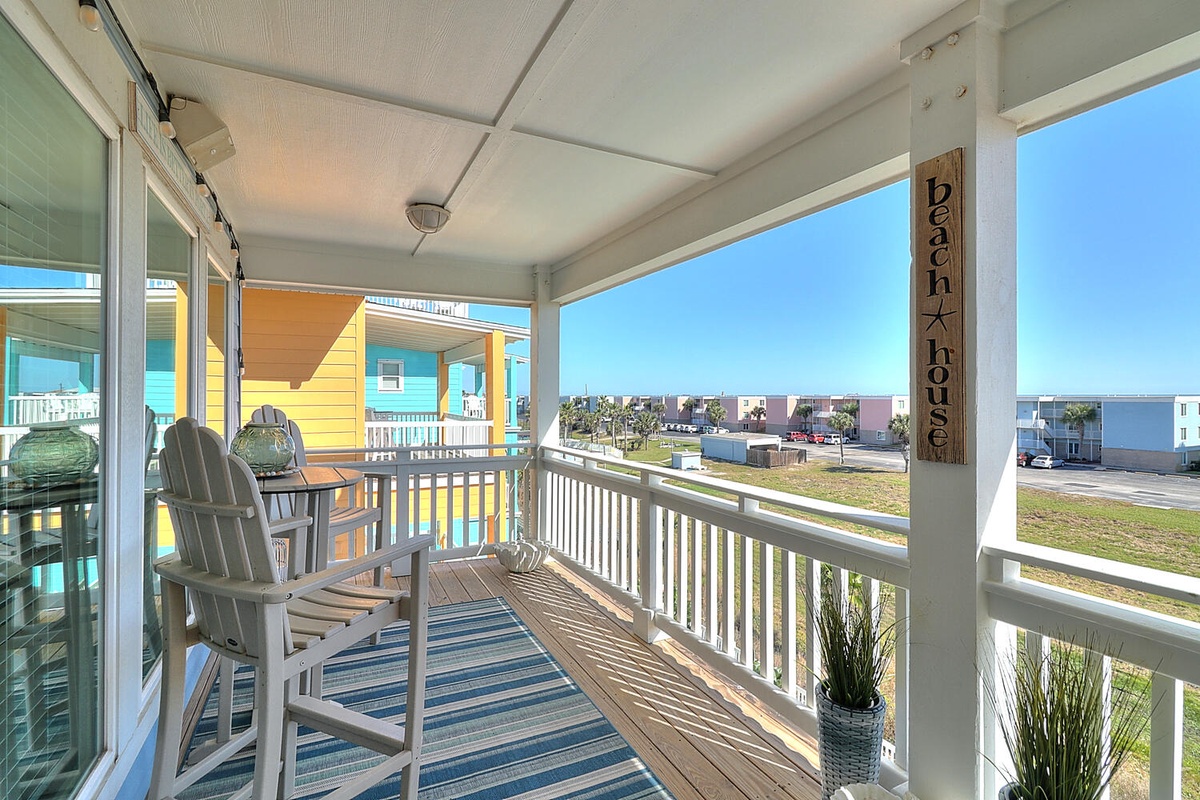 Relax on your covered porch with comfortable seating and refreshing coastal breezes while enjoying colorful neighborhood views.