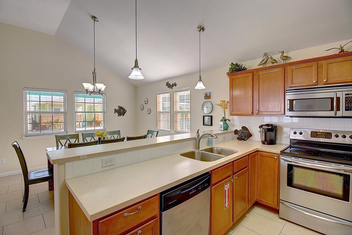 Your spacious kitchen awaits with warm wood cabinets, granite counters, and stainless appliances—perfect for cooking meals together.