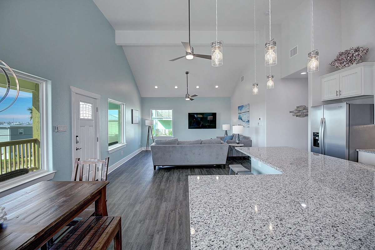 Your spacious open-plan living area blends kitchen, dining, and lounge seamlessly with granite counters and coastal-inspired design.