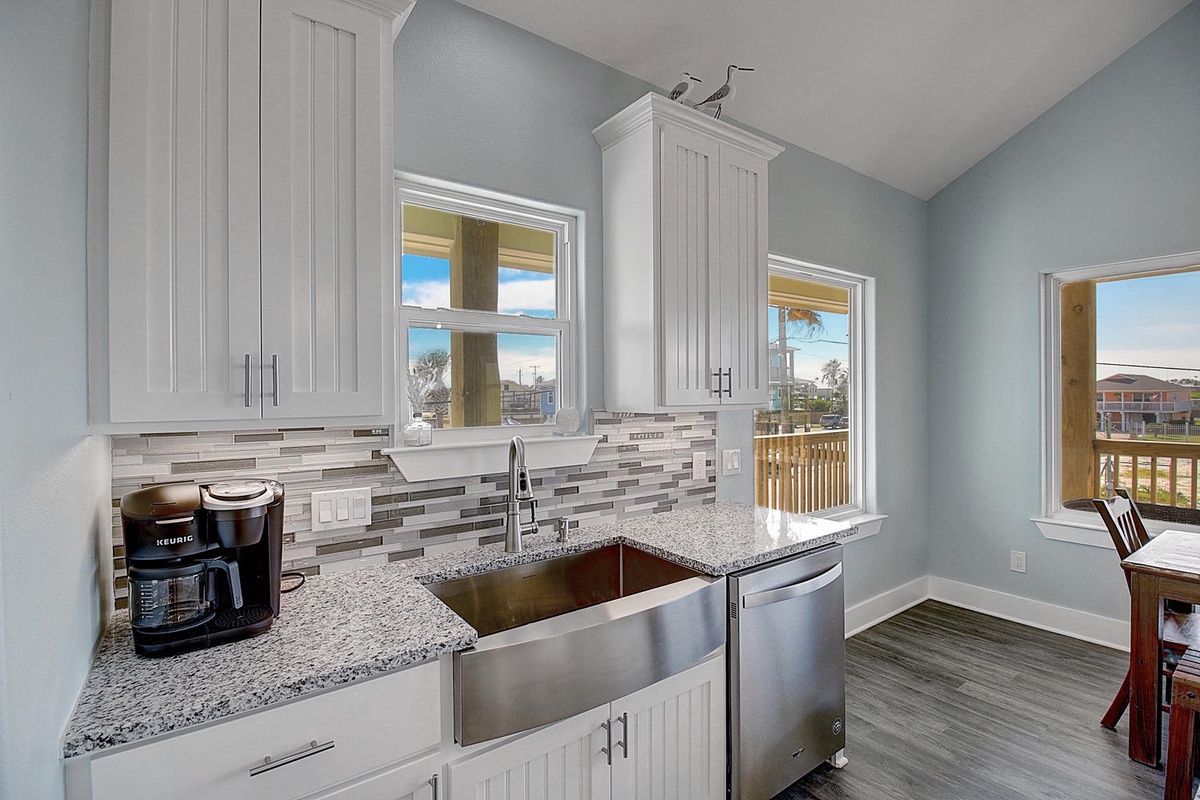 Your fully equipped kitchen features granite countertops, stainless steel appliances, and stunning water views through every window.