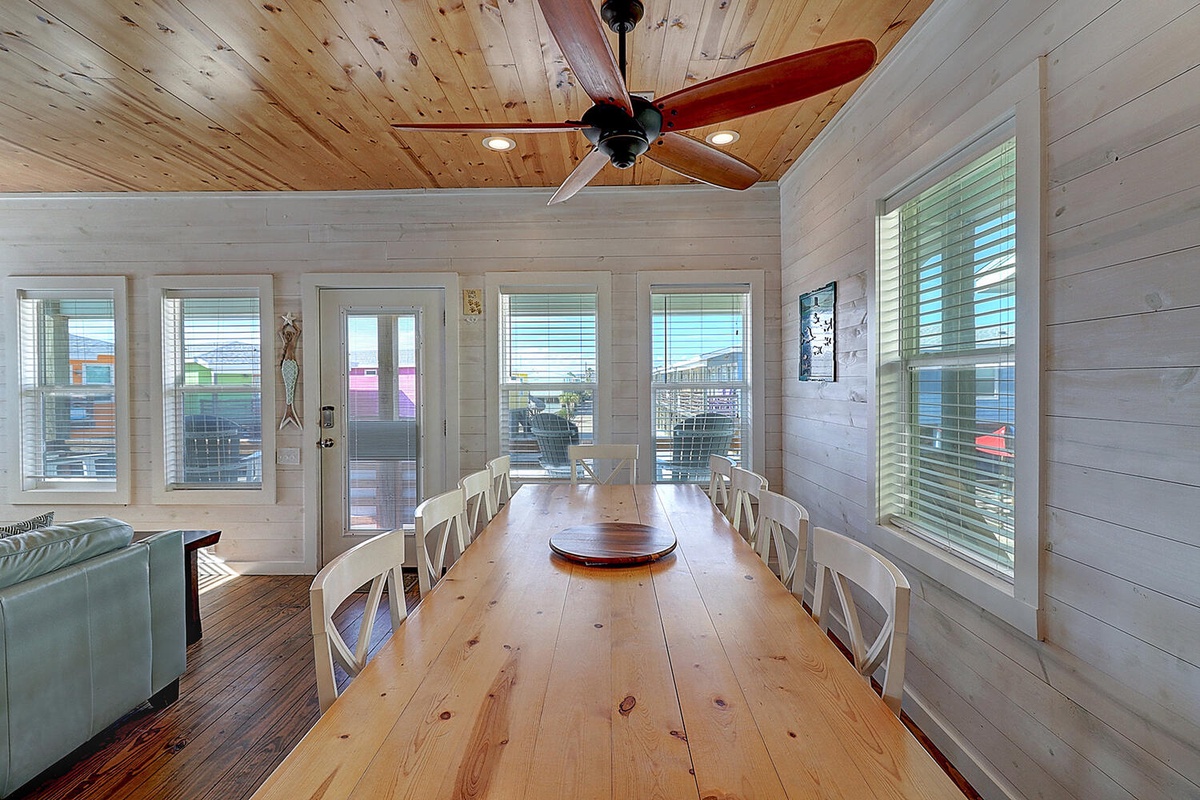 Gather your family around this gorgeous farmhouse dining table beneath rustic pine ceilings and enjoy meals together.