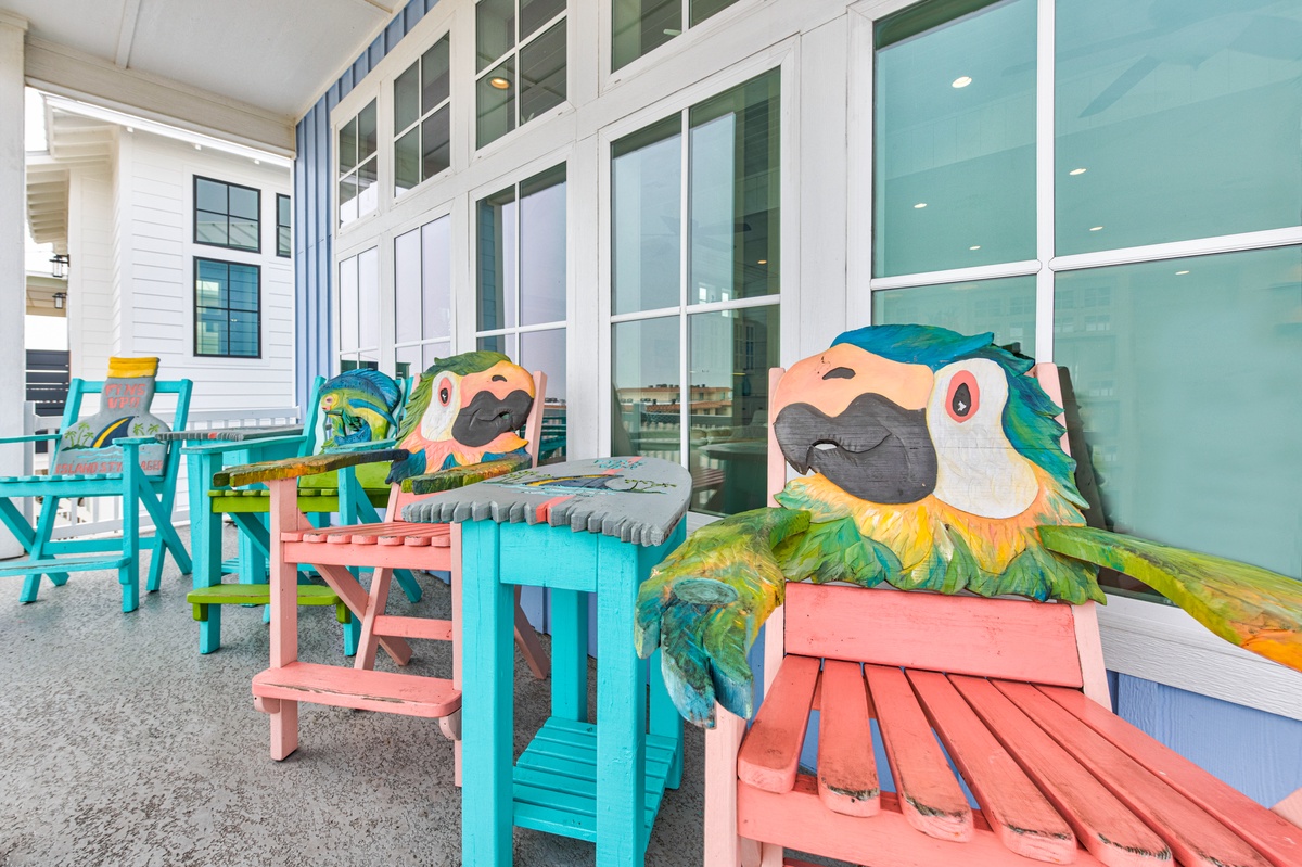 Relax on your private covered patio with whimsical parrot-themed seating and vibrant tropical colors that set a fun, beachy mood.