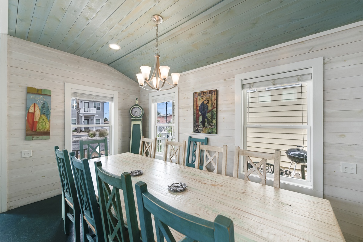 Gather your group around this charming farmhouse dining table, where whitewashed walls and seafoam accents create a coastal retreat perfect for memorable meals.
