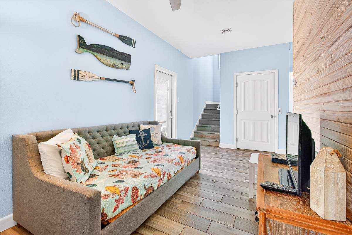 Unwind in your coastal-themed living space with nautical touches, cozy seating, and charming wood accents that create the perfect beach house atmosphere.