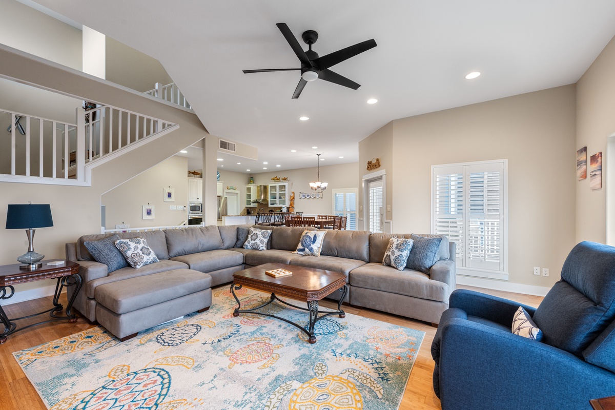 Relax in your spacious living room with plush sectional seating, elegant décor, and open layout that flows to the kitchen.