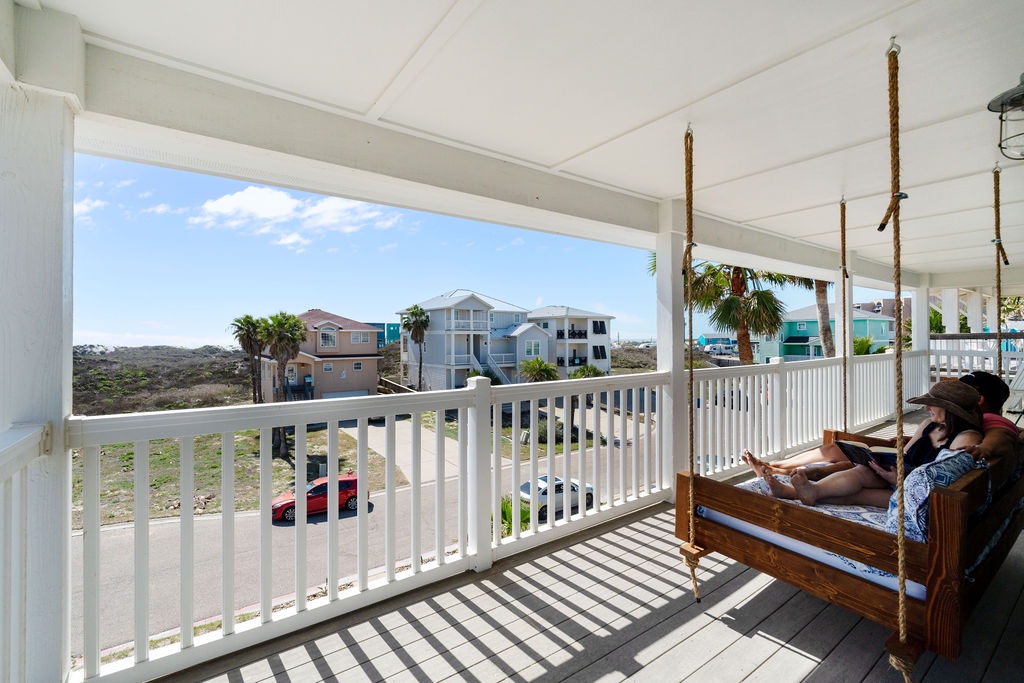 Swing gently on your private porch swing while taking in panoramic views of colorful beach houses and coastal scenery.