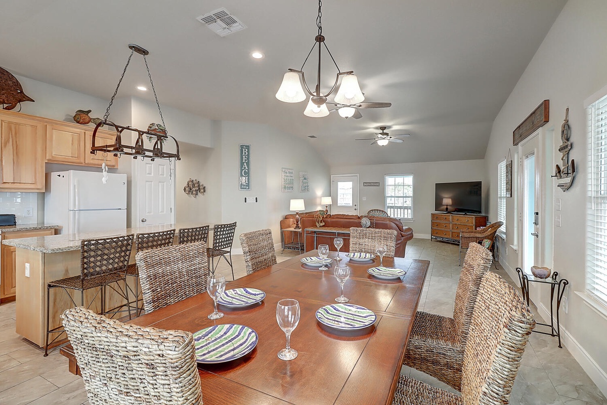 Gather around this spacious dining table where your group can share meals and create memories in this open-concept space.