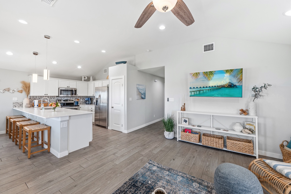 Step into a bright, open living space where coastal charm meets modern comfort. The fully equipped kitchen and inviting seating area create the perfect spot to unwind after your adventures.
