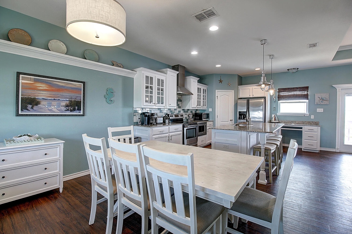 Cook and dine together in this elegant space with modern appliances, coastal charm, and room for everyone to gather.