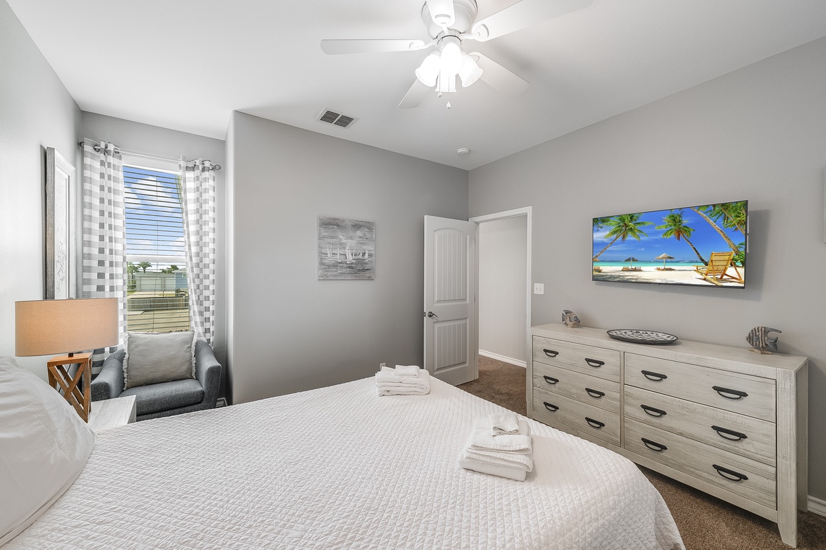 Your peaceful bedroom features a comfortable bed, spacious dresser, and cozy seating area where you can unwind after exploring.