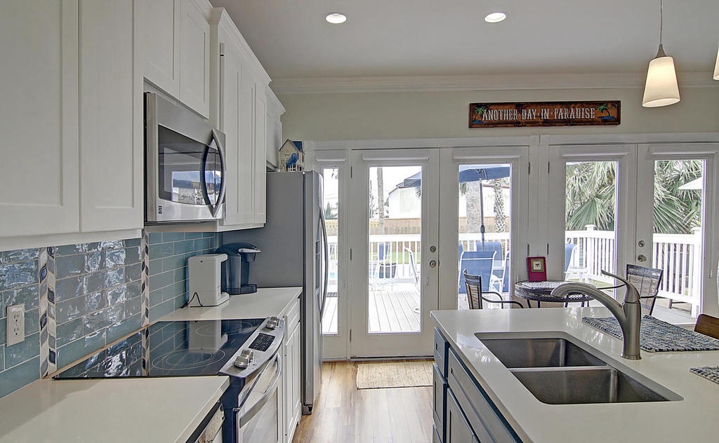 Your bright, beachy kitchen opens to a private balcony where coastal breezes and palm views create the perfect backdrop for morning coffee or evening cocktails.