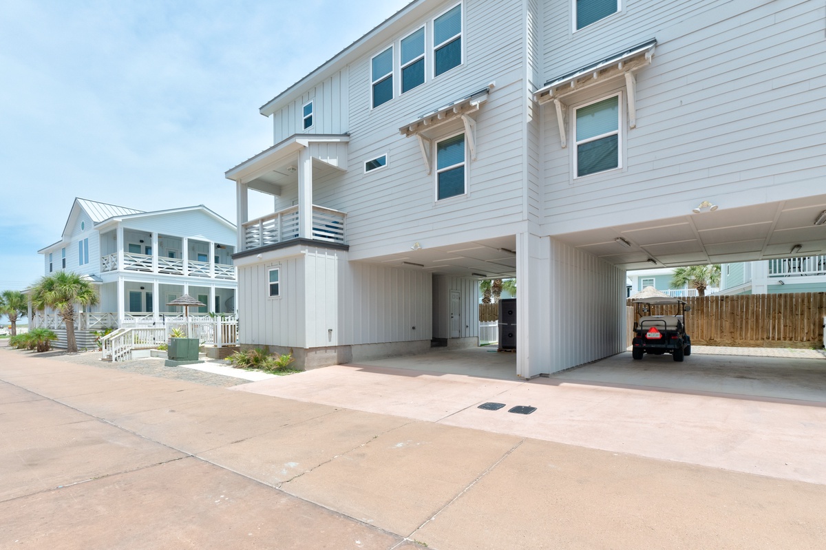 Modern coastal home featuring covered parking and stylish architecture in a beachside community setting.