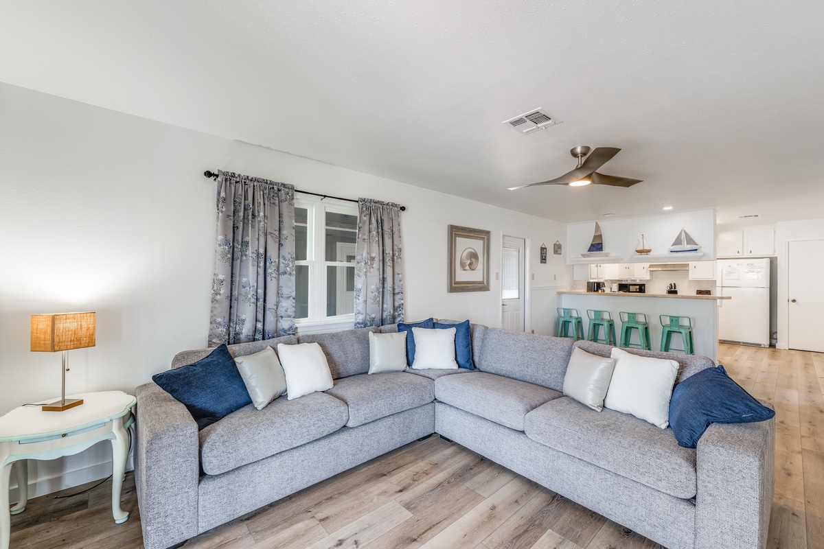 Sink into your spacious sectional sofa and feel completely at home in this bright, coastal-inspired living space.
