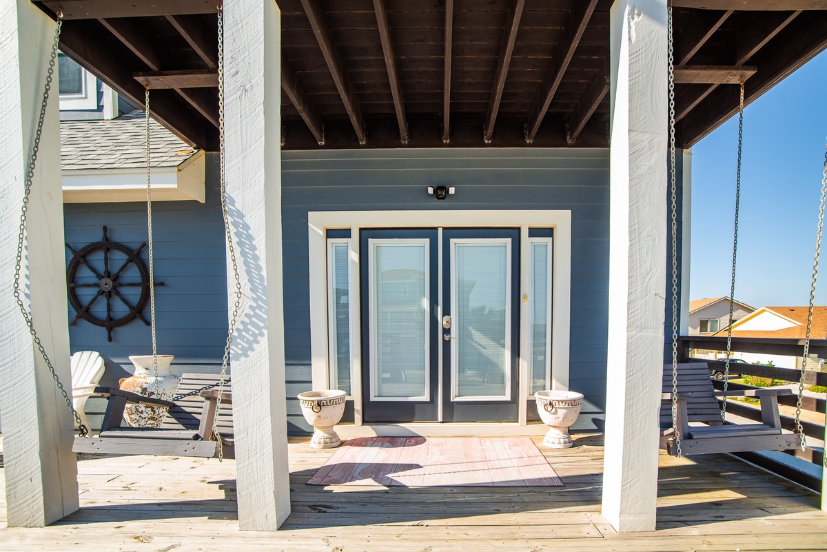 Your charming coastal entrance welcomes you with nautical charm and peaceful porch swings for morning coffee moments.