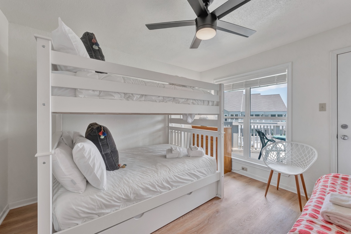 Your kids will love this bright bunk room with ocean views and a cooling ceiling fan for perfect summer nights.