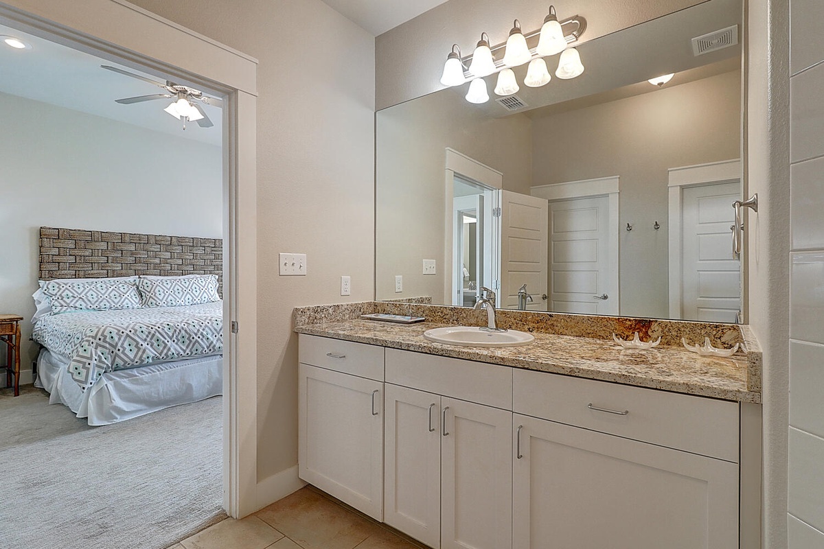Your ensuite bathroom features elegant granite countertops, dual sinks, and bright vanity lighting for your morning routine.
