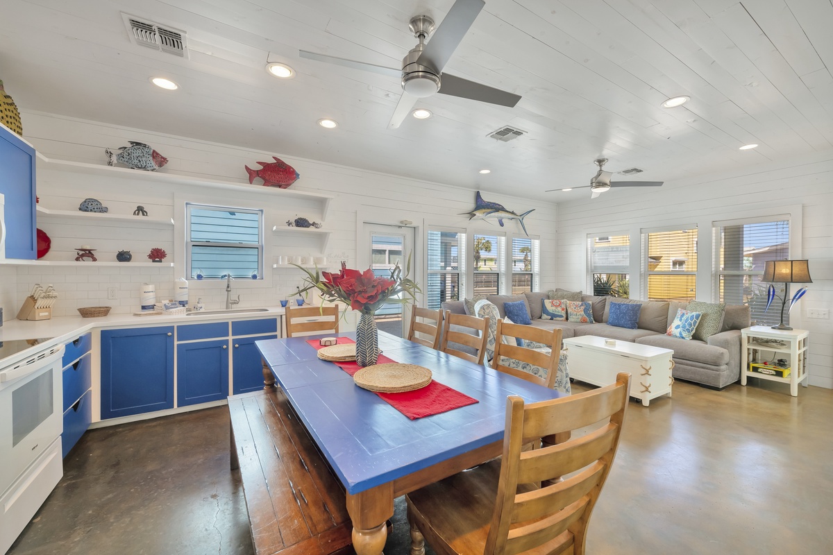 Your coastal-themed open-plan space blends kitchen and living areas with charming nautical touches and comfortable seating for memorable gatherings.