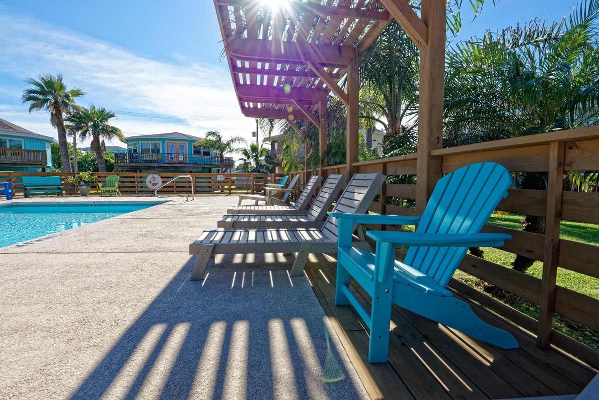 Unwind by the sparkling pool in your own shaded lounge chairs, where tropical palms create the perfect vacation backdrop.