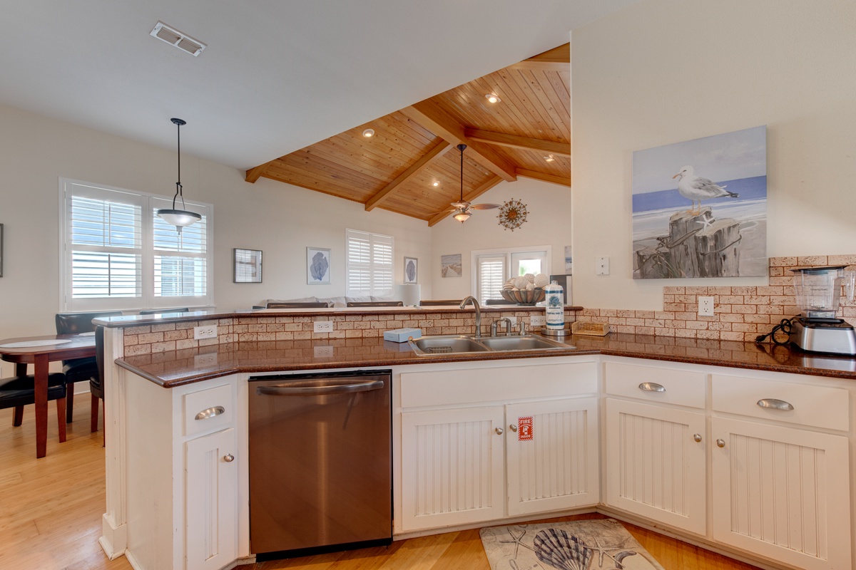 Your spacious kitchen features granite counters, stainless appliances, and charming exposed beams overhead for memorable meal prep.