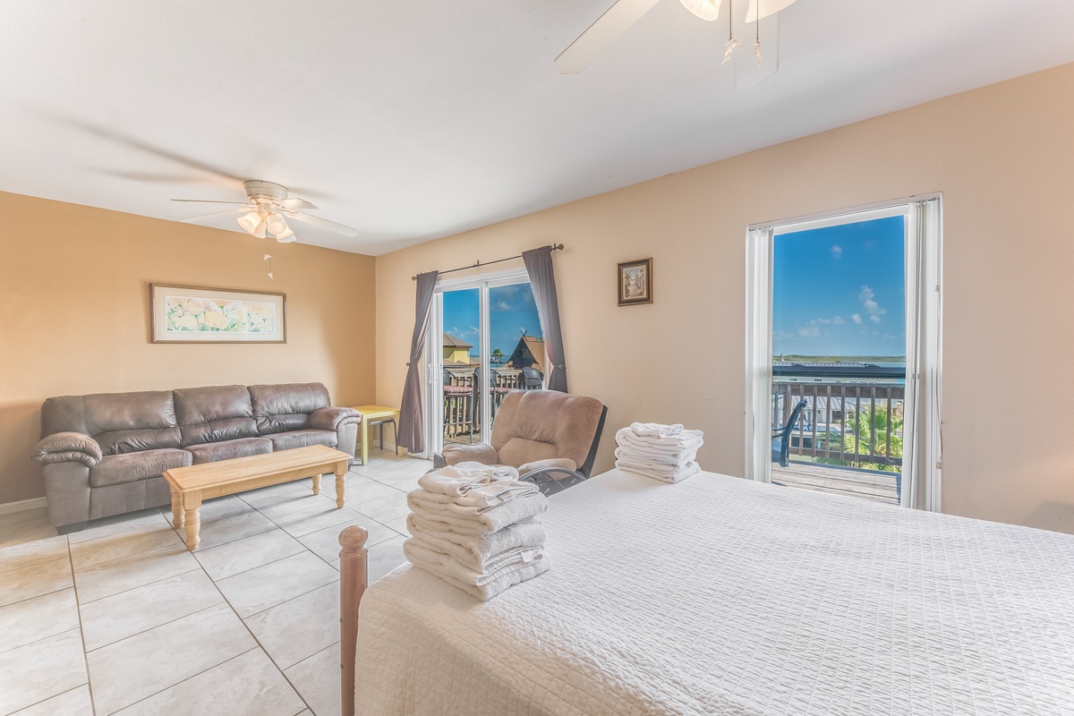 Relax in your bright, spacious bedroom with water views. Fresh towels await while ceiling fans keep you comfortable.