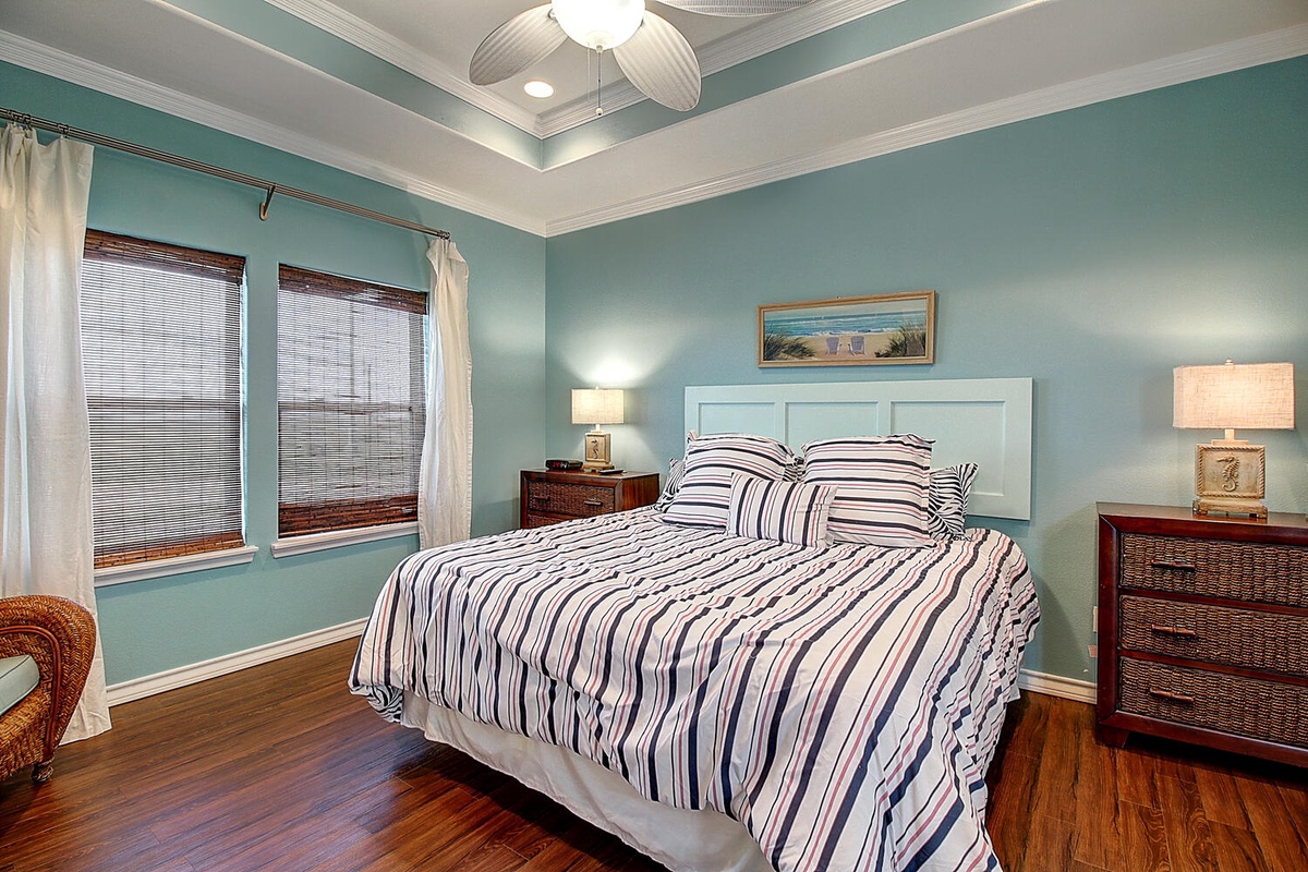 Your peaceful bedroom sanctuary features soothing coastal colors, crisp linens, and gentle ceiling fan breezes for perfect sleep.