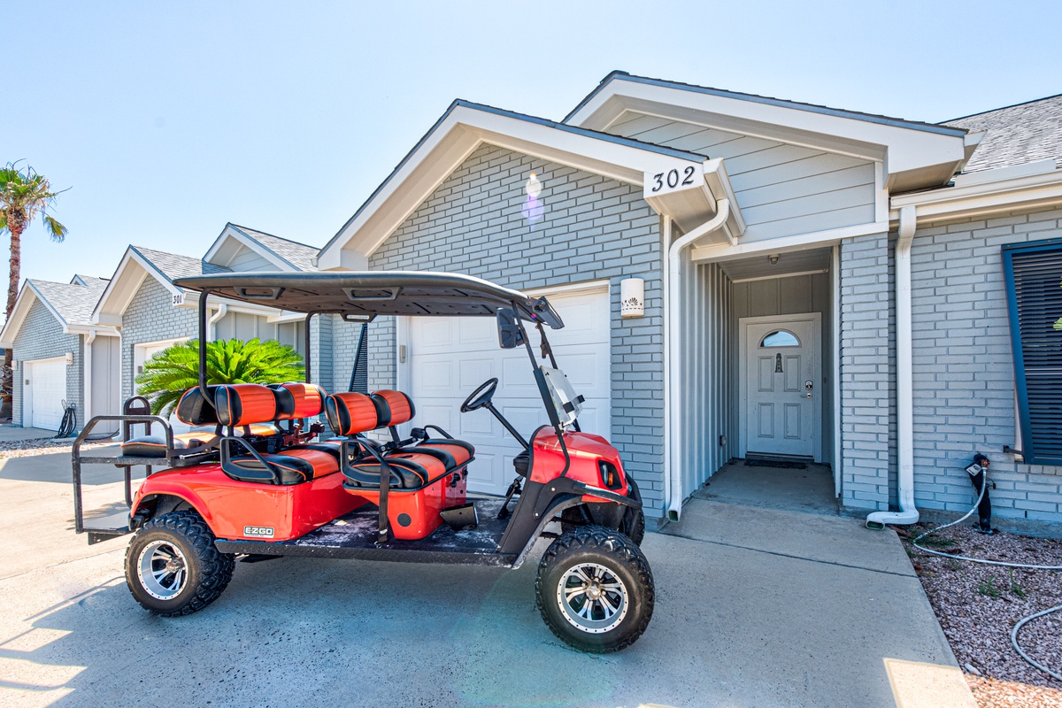 Modern vacation home with convenient golf cart for exploring the area, complete with covered parking and easy beach access.
