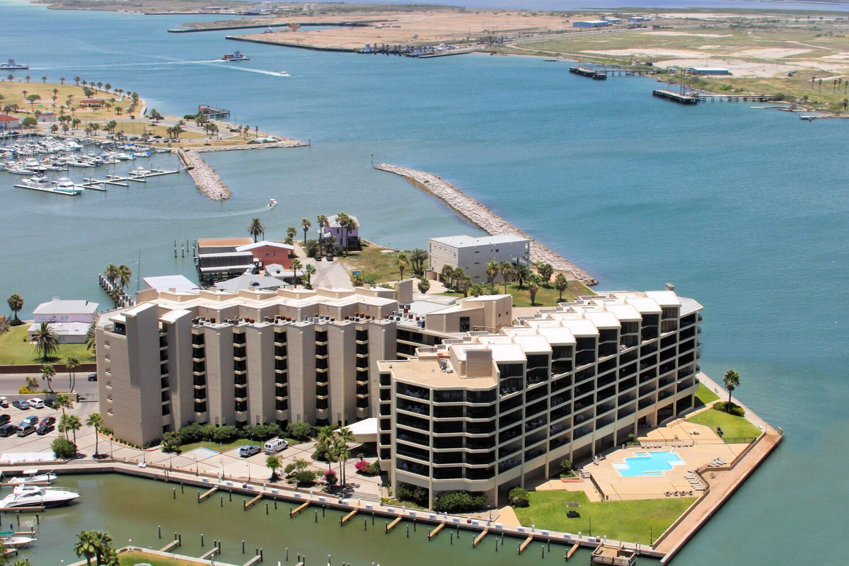 Waterfront resort complex with marina access and bay views in a scenic coastal setting.