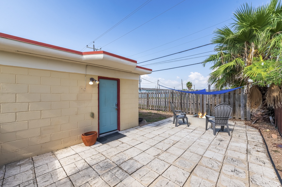 Relax on your private patio with comfortable seating under tropical palms and clear blue skies.