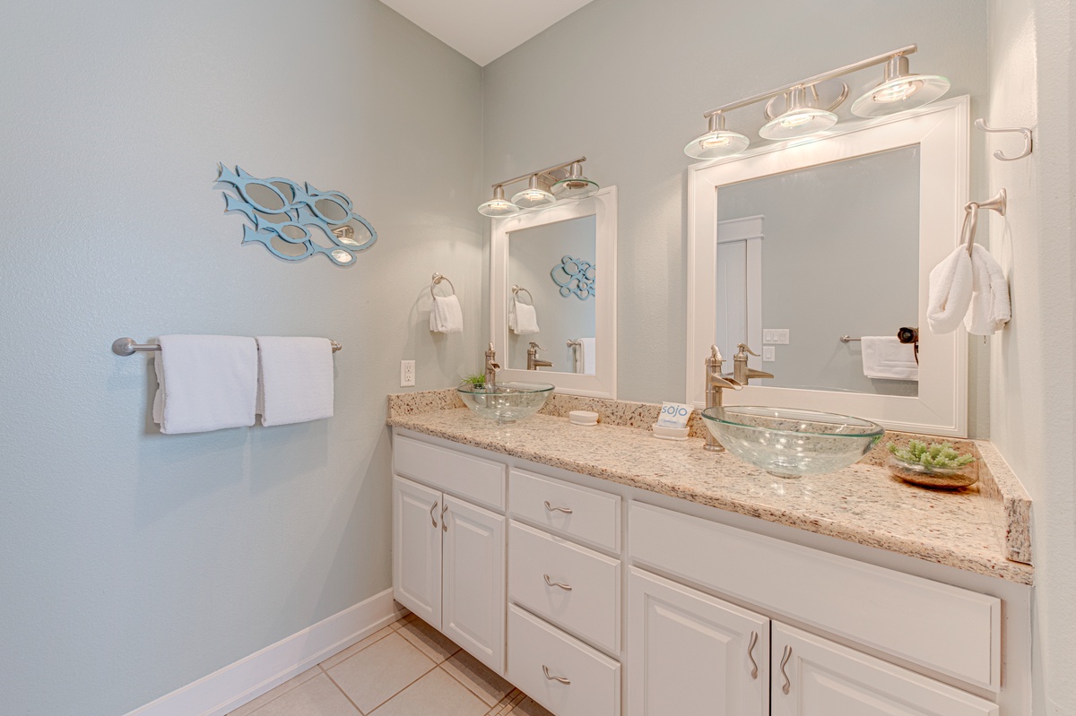 Your elegant bathroom features dual vanities with granite counters and stylish lighting, making your morning routines feel luxurious.