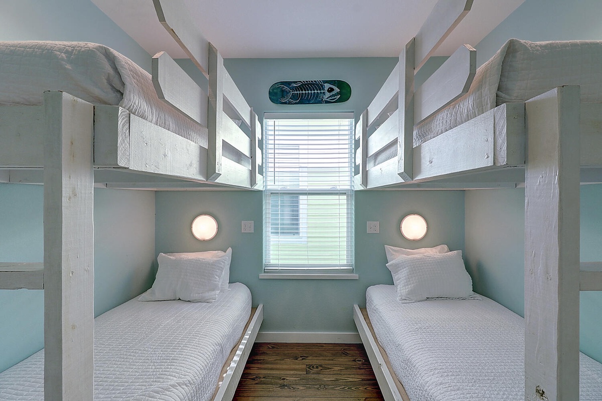 Your cozy bunk room features built-in beds with personal reading lights and crisp linens for restful nights.