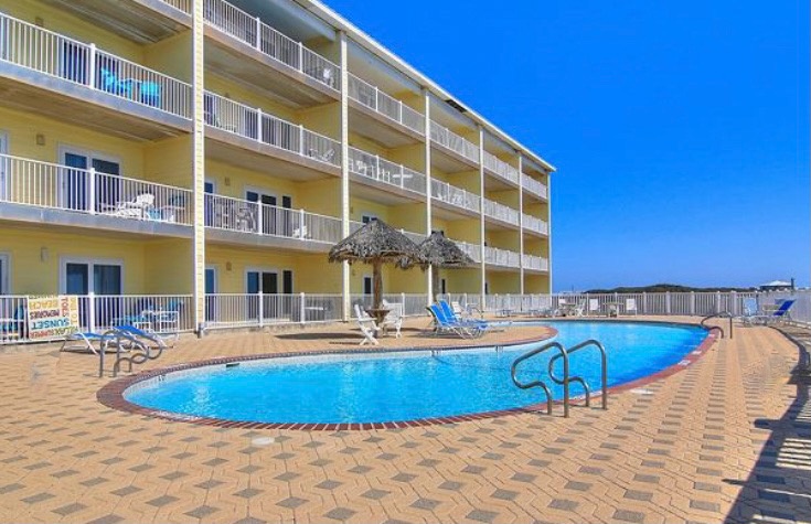 Dive into crystal-clear waters steps from your balcony. This sparkling pool awaits your morning swim and afternoon relaxation.