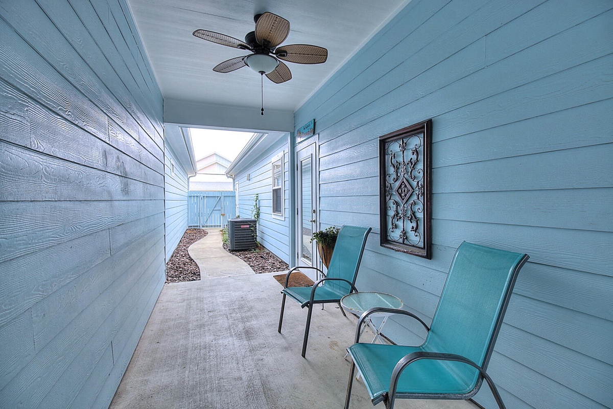 Unwind on your private covered patio with comfortable seating and ceiling fan, creating the perfect spot to relax after a day of exploring.
