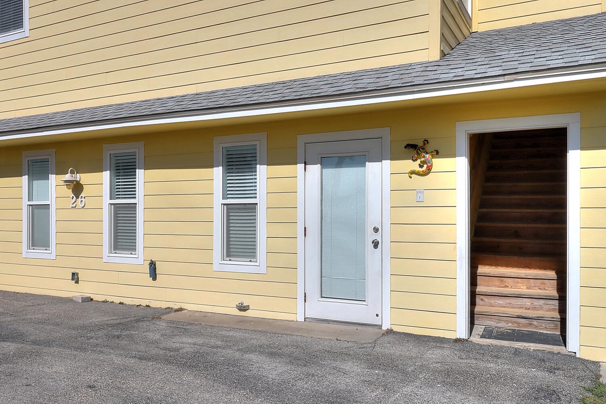 Bright yellow exterior with charming nautical touches and convenient ground-floor entrance to your coastal retreat.