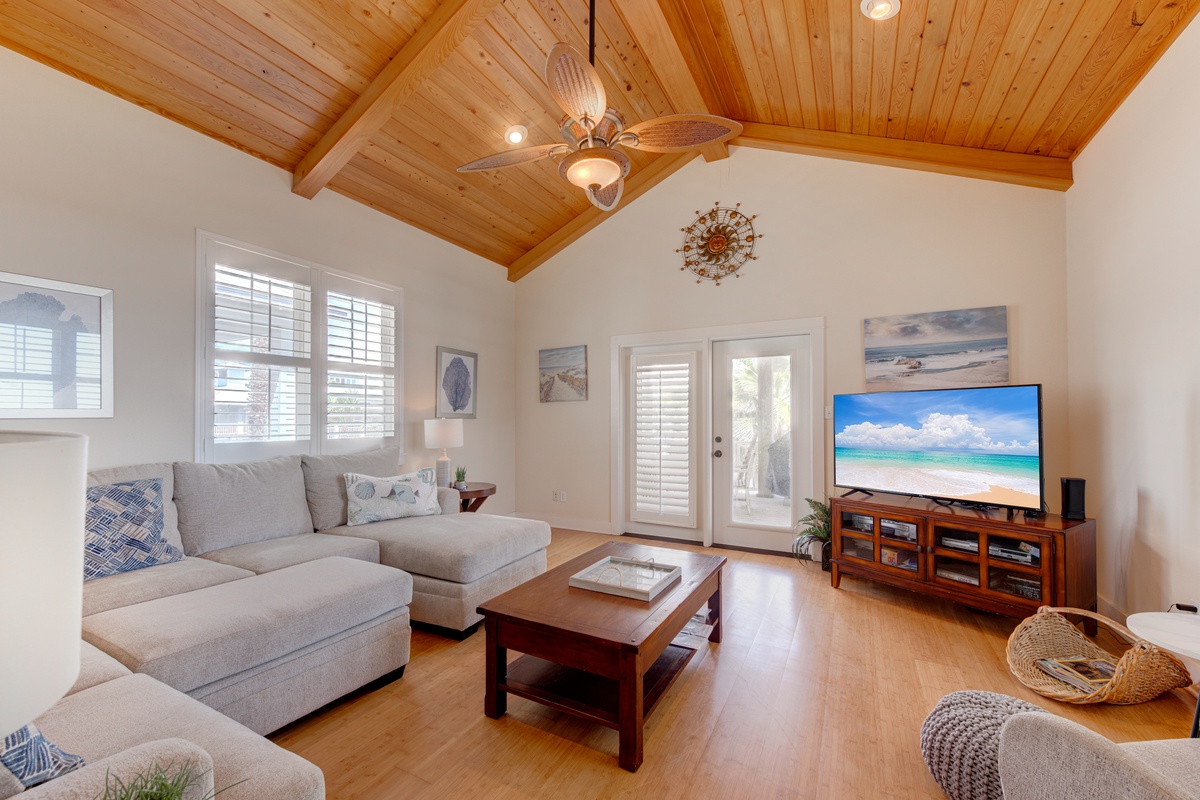 Unwind beneath soaring wood ceilings in your spacious living room, where soft sectional seating invites movie nights.