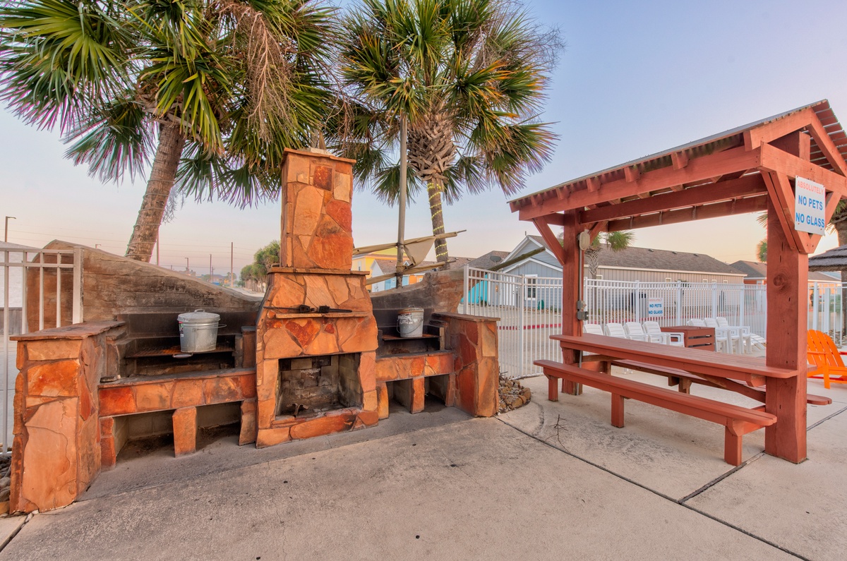 Fire up the grill at this beachside BBQ station, complete with picnic tables under swaying palms for your perfect outdoor feast.